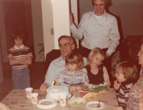 Dick Loges, Army veteran, surrounded by his family at the dinner table.